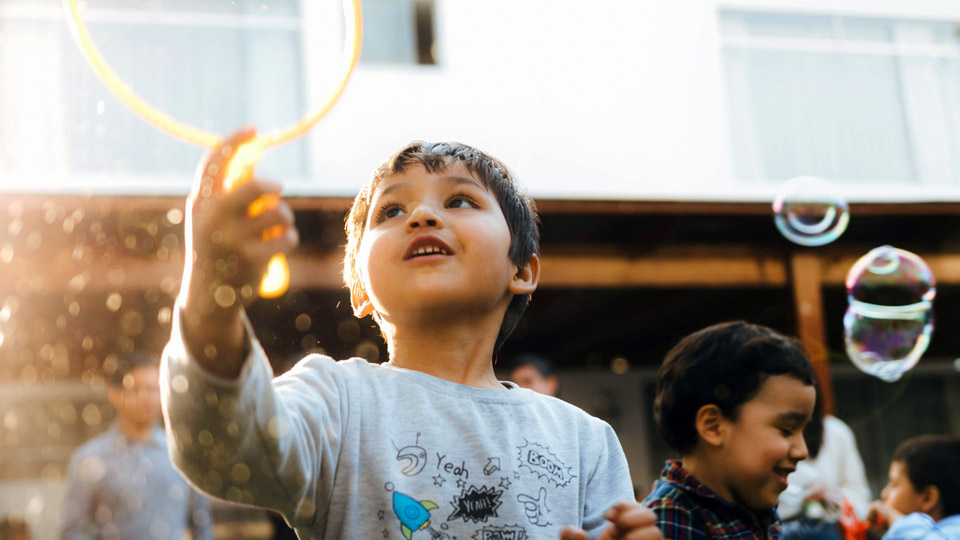 Children playing with soap bubbles outside